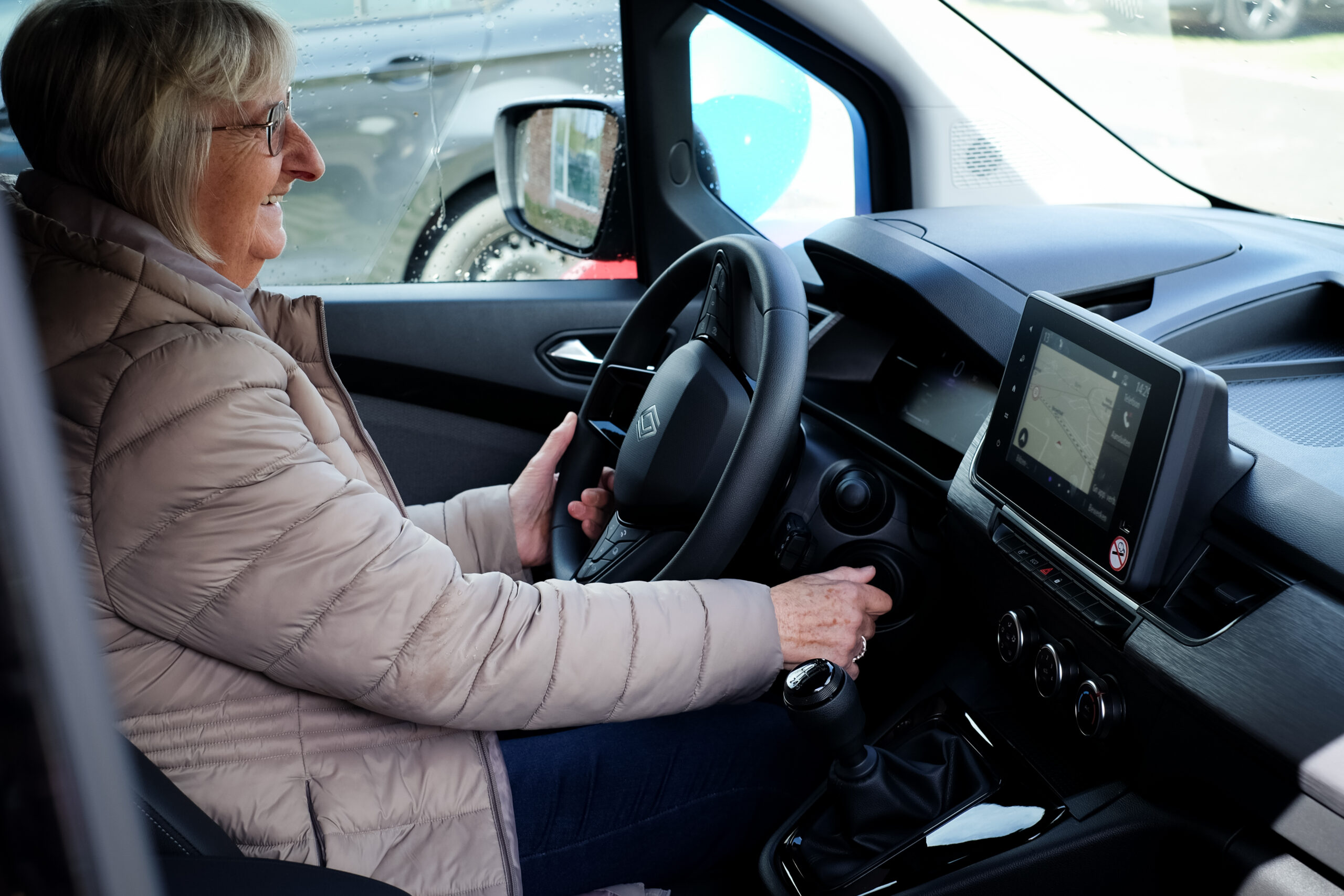 Vrouw achter stuur van deelwagen